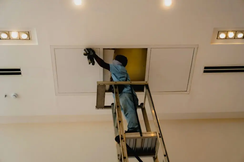 Electrician installing modern recessed lighting in a renovated Chicago kitchen - Remodel electrician Chicagoland