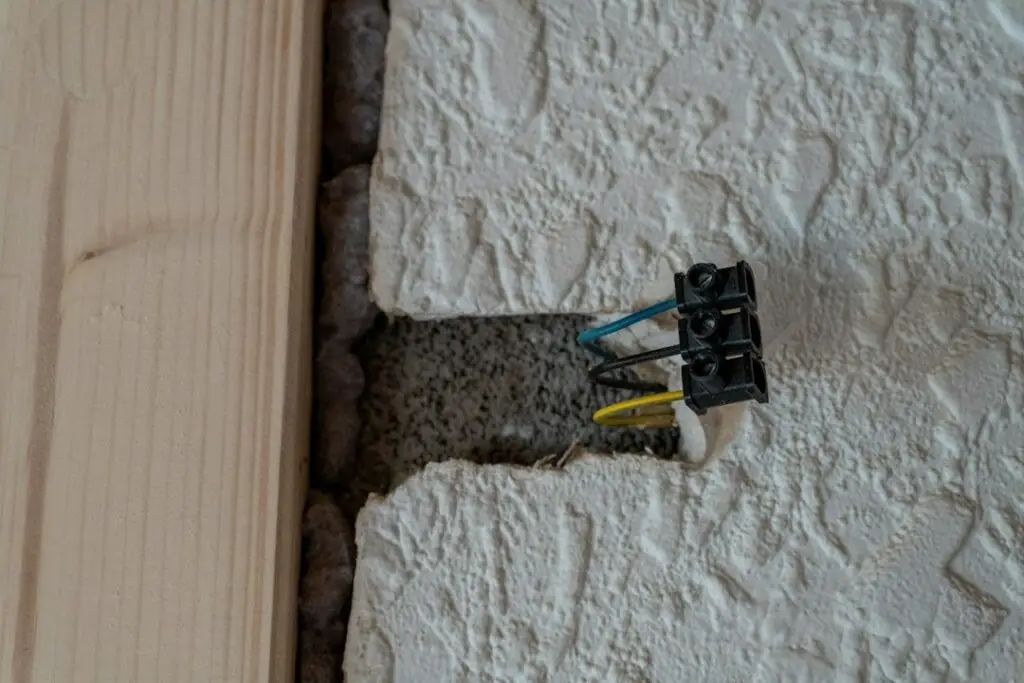 frayed old electrical wiring in wall