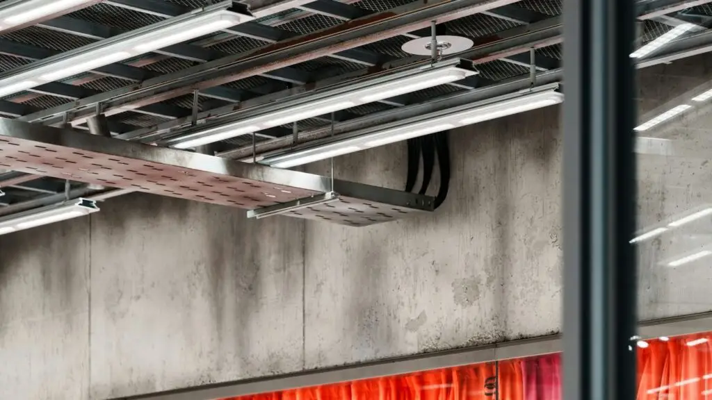 Industrial ceiling with lights and concrete wall
