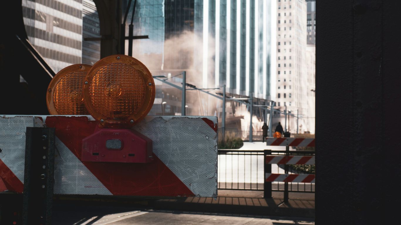 a red and white barricade on a city street