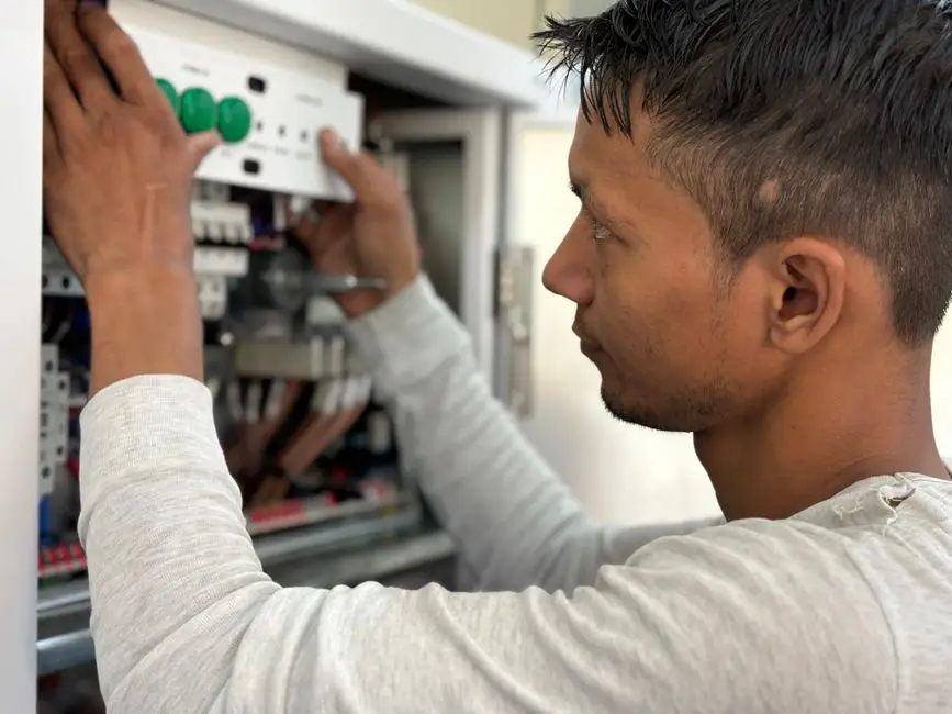 An electrician installing a new breaker box in a Chicago home