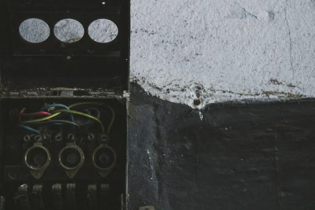 Interior of a main breaker panel showing hot bus bars, neutral bar, and breakers